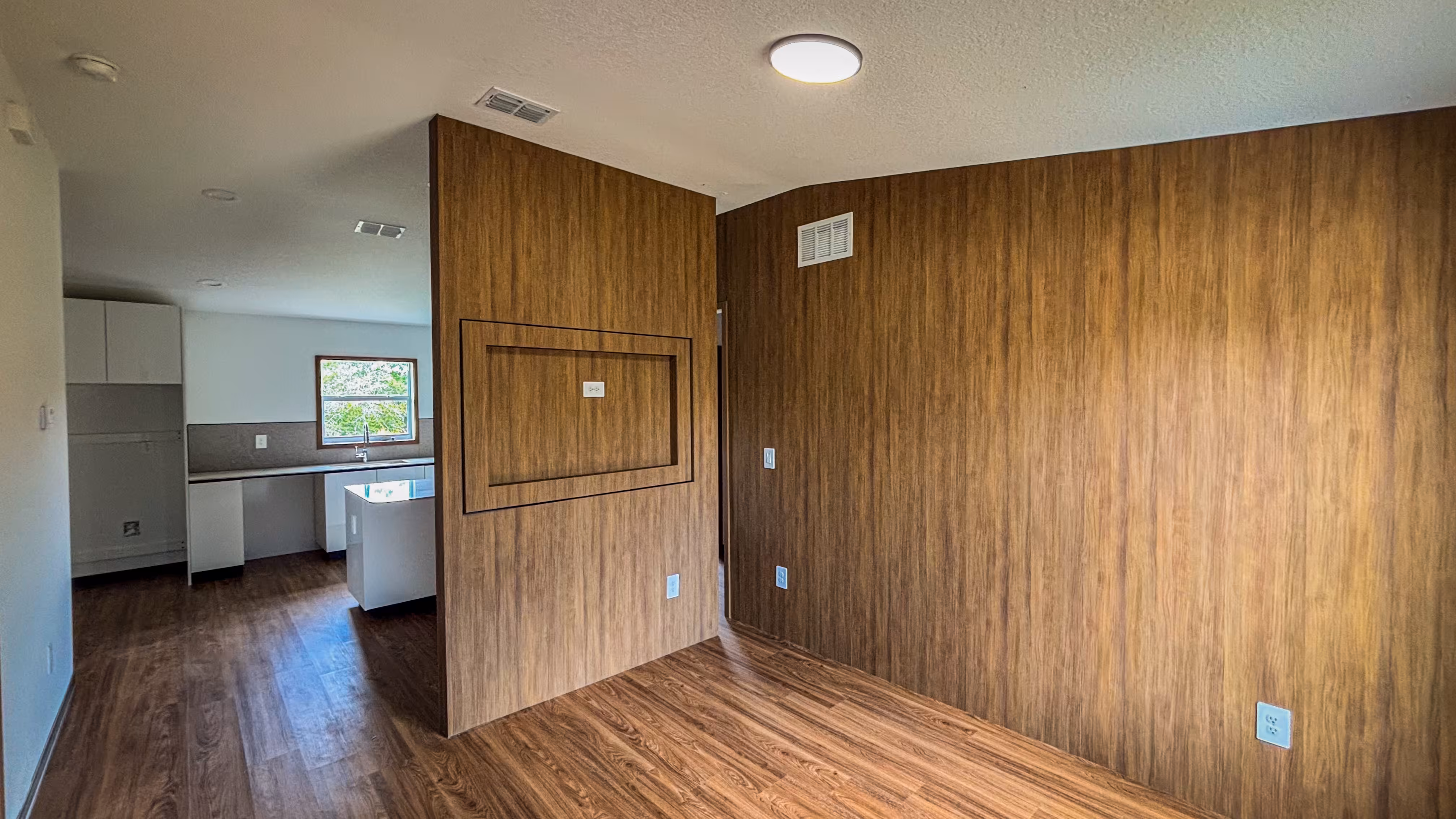 Bedroom addition with dark LVP flooring and built-in closet